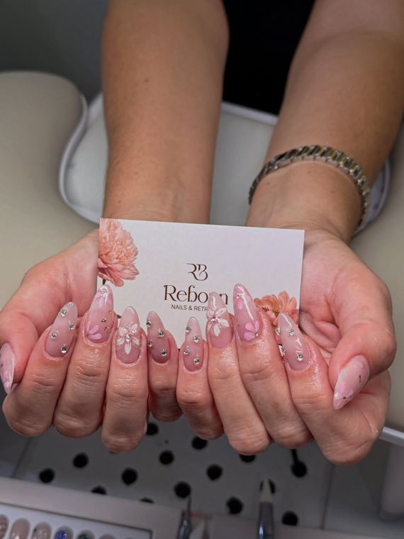 Hand-painted florals with charms · on our card at Reborn Nails & Retreat Da Nang